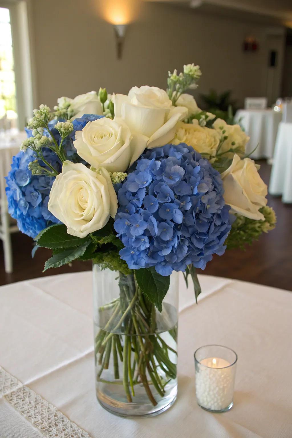 An overflowing botanical composition featuring azure hydrangeas and ivory roses crafts a captivating centerpiece.