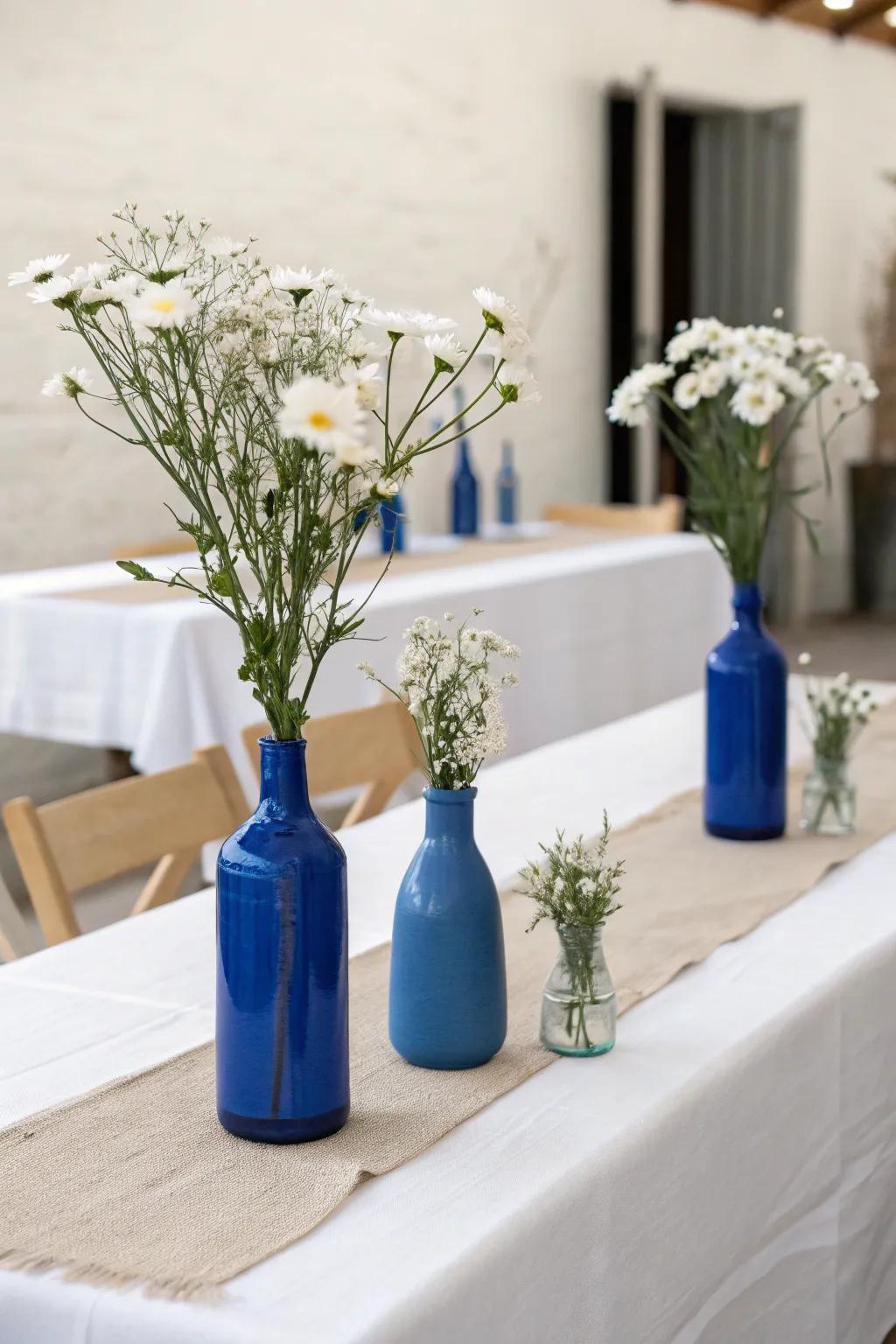 Simple azure vases with single-type flowers provide understated refinement.