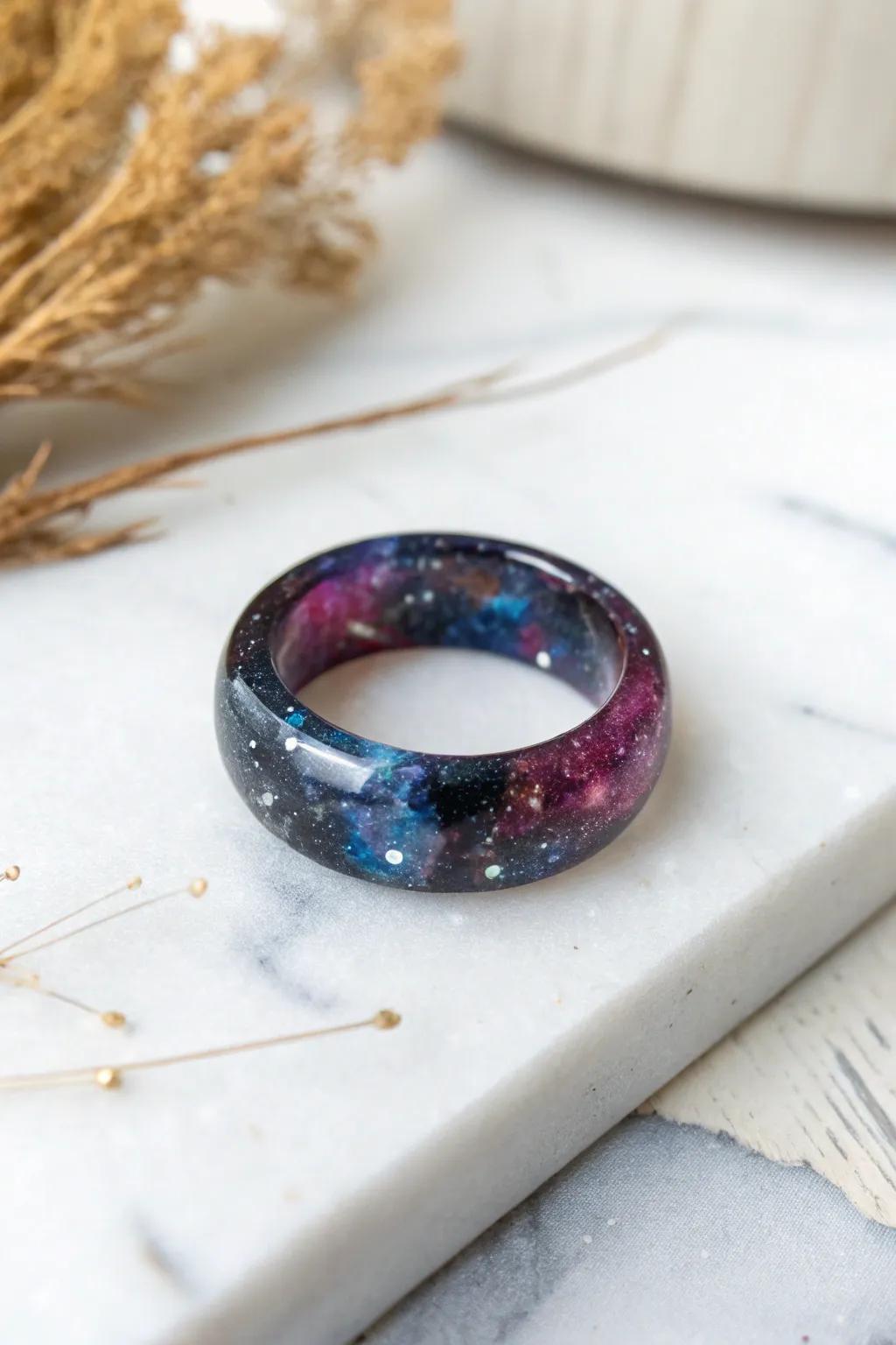 Embrace the universe with this galaxy-inspired resin ring, where elegance converges with the cosmos.