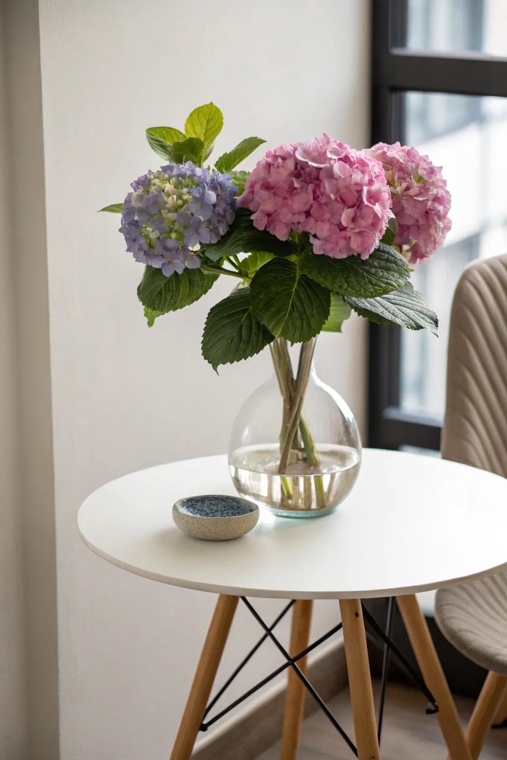A single hydrangea within a brandy vase offers understated splendor.