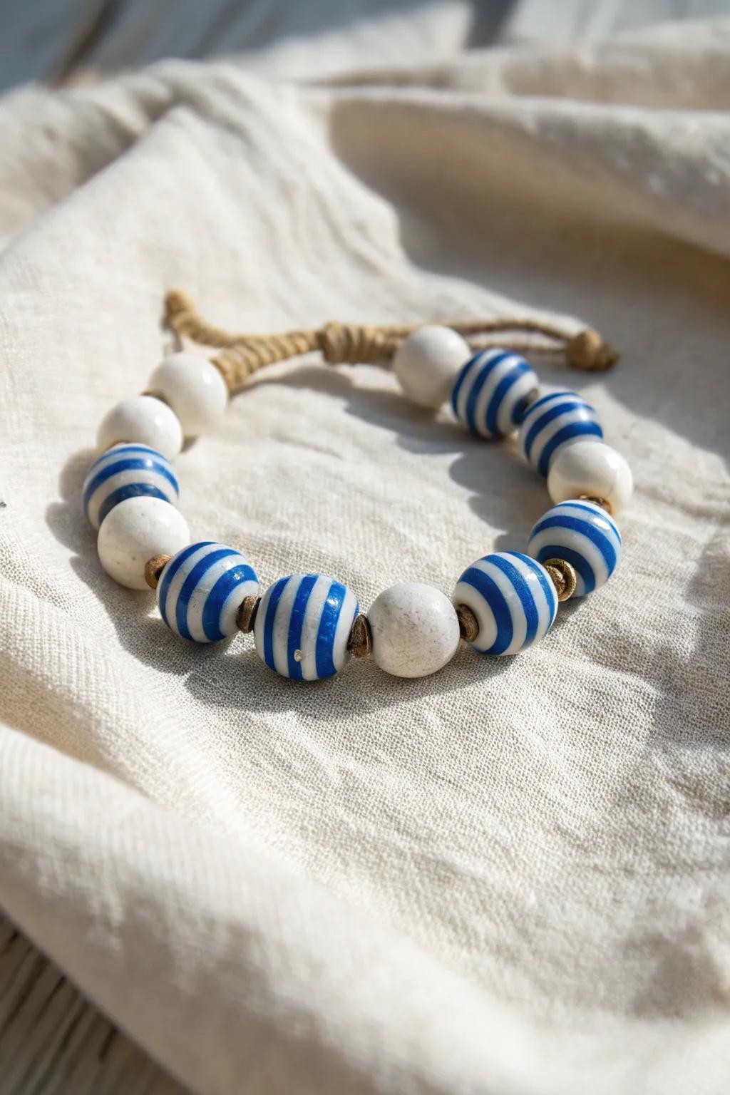 Capture the maritime allure of summer with this exquisitely fashioned sapphire and white striped clay bead bracelet. Impeccable for contributing a touch of elegance to any attire.