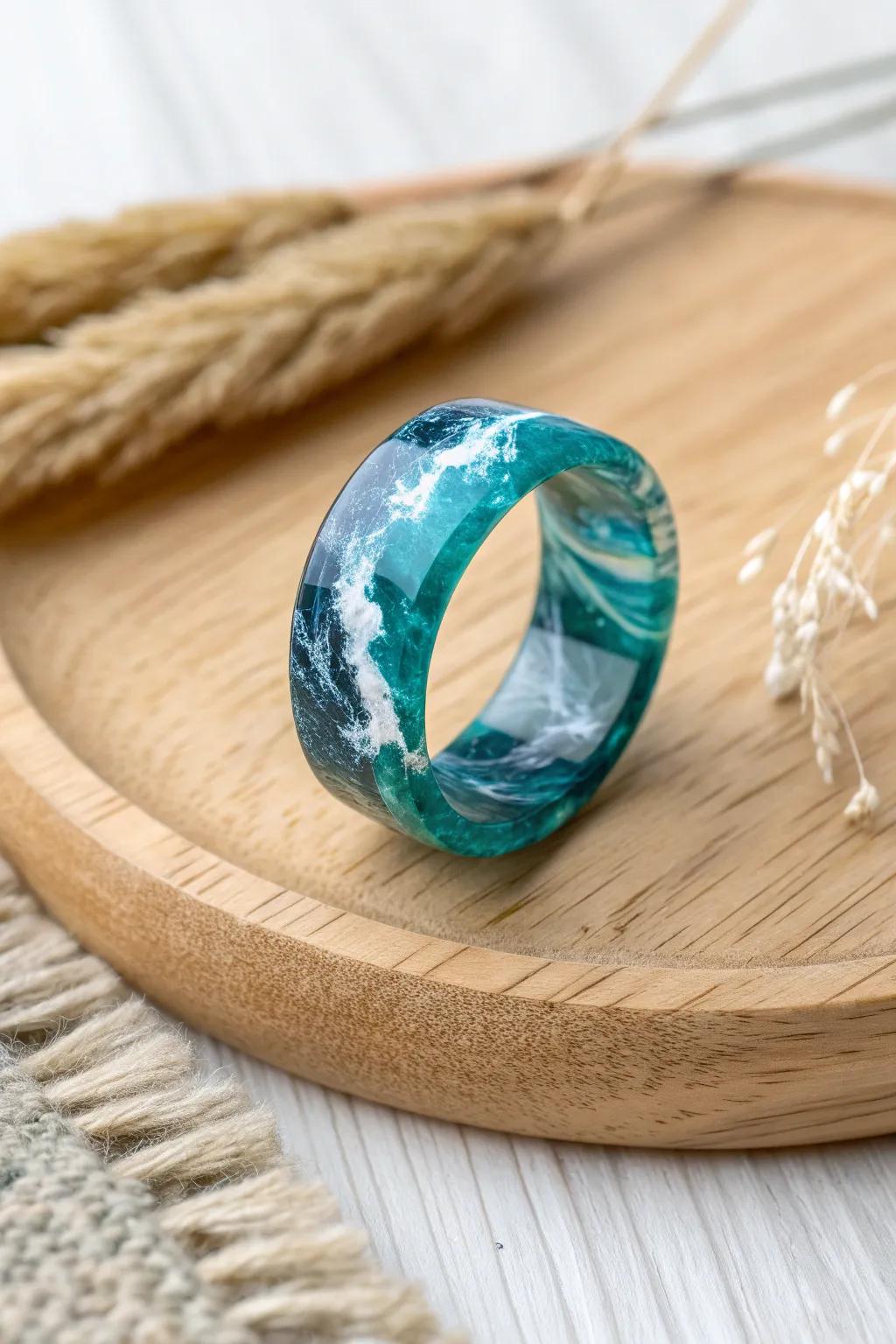 Immerse yourself in the allure of turquoise waters with this stunning resin ring. A flawless fusion of skill and organic appeal.