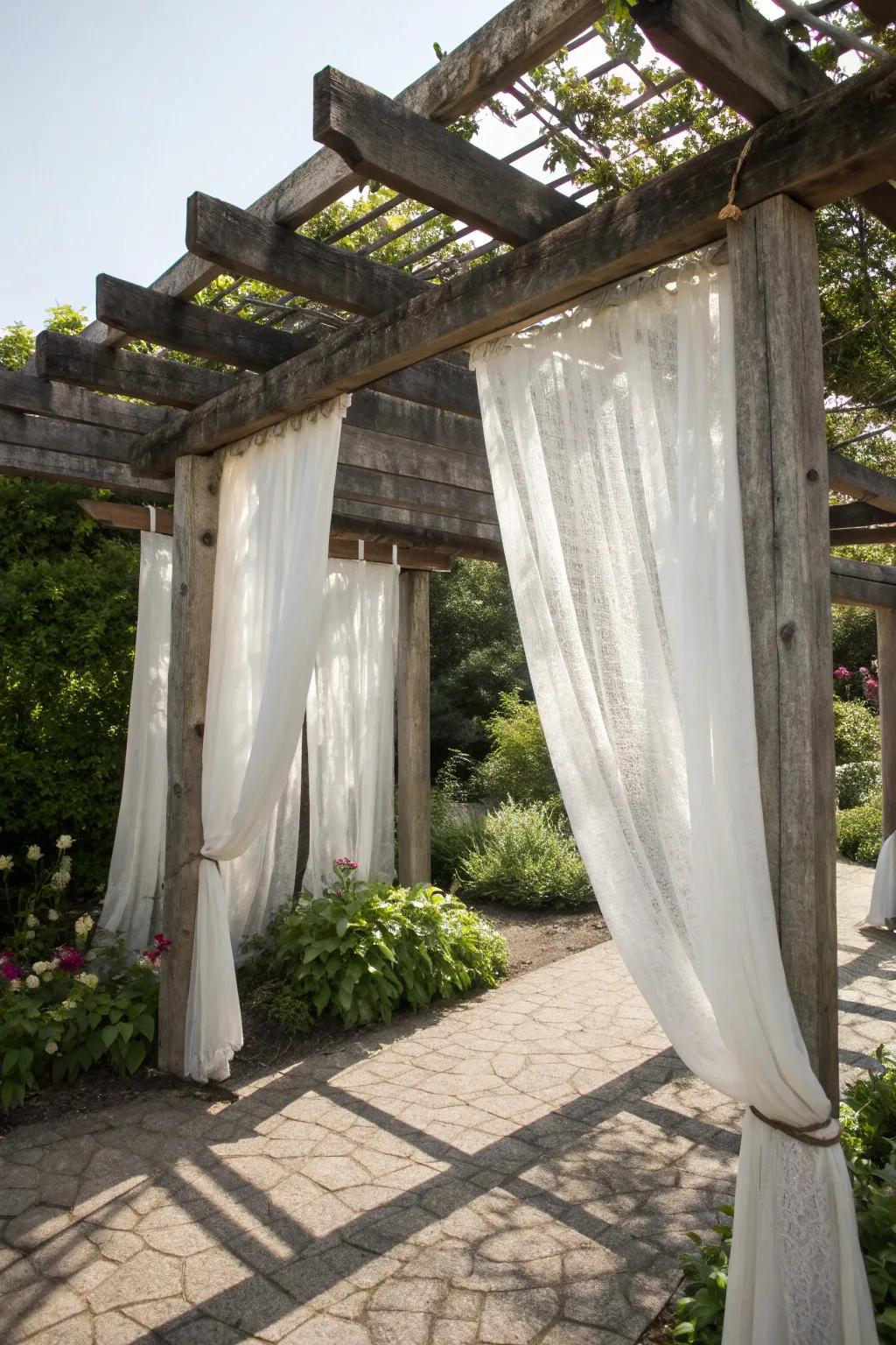 Transform your backyard into a rustic escape with a pergola enveloped in sophisticated draperies.