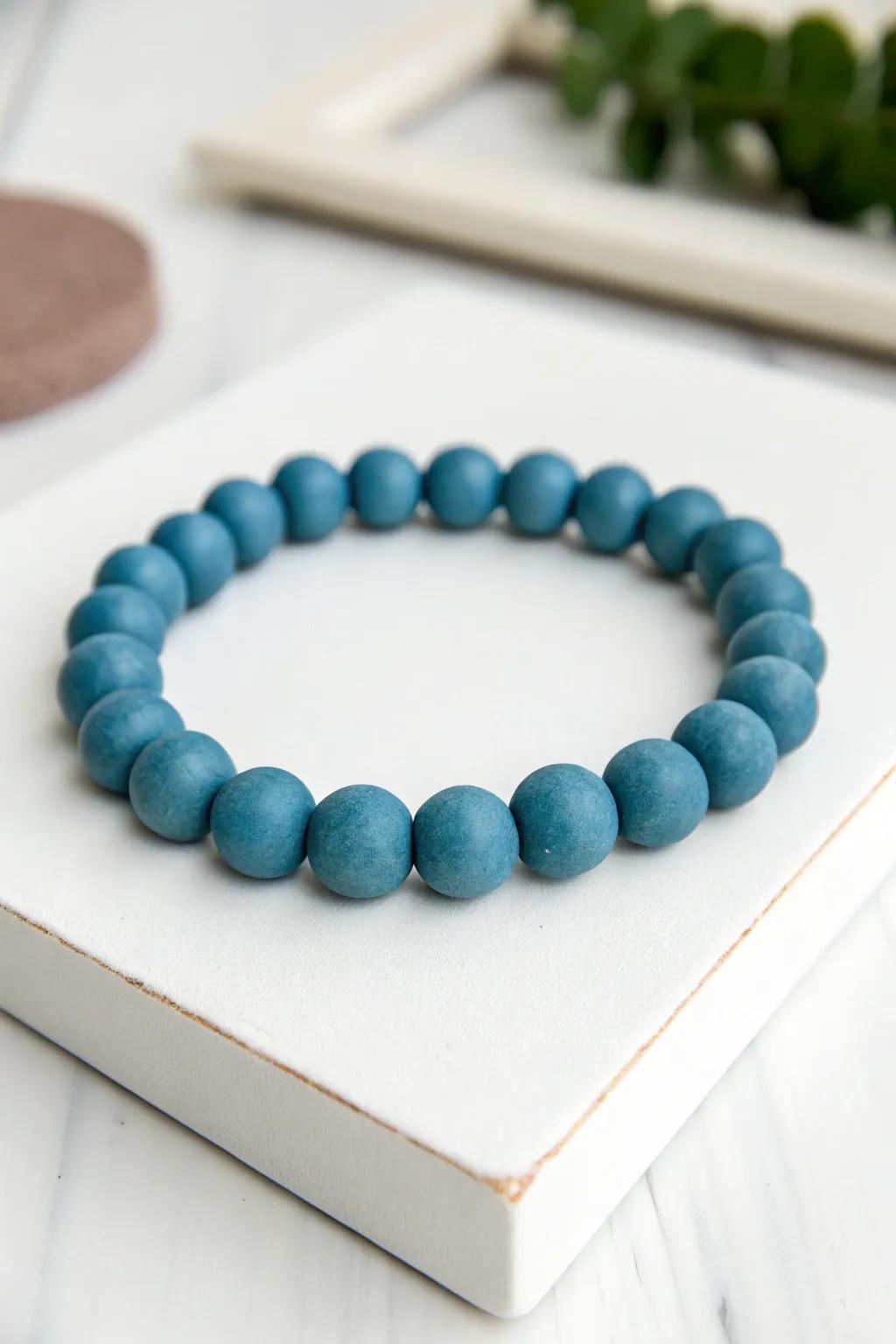 Capture the elegance of minimalism with this subtle azure clay bead bracelet.