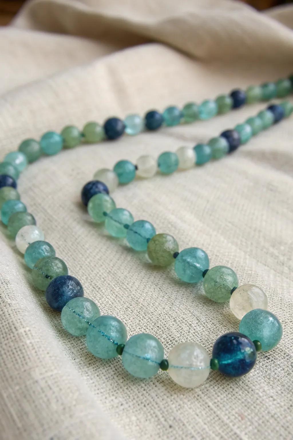 Eco-Chic Beauty: Embrace sustainability featuring a distinctive recycled glass bead necklace.