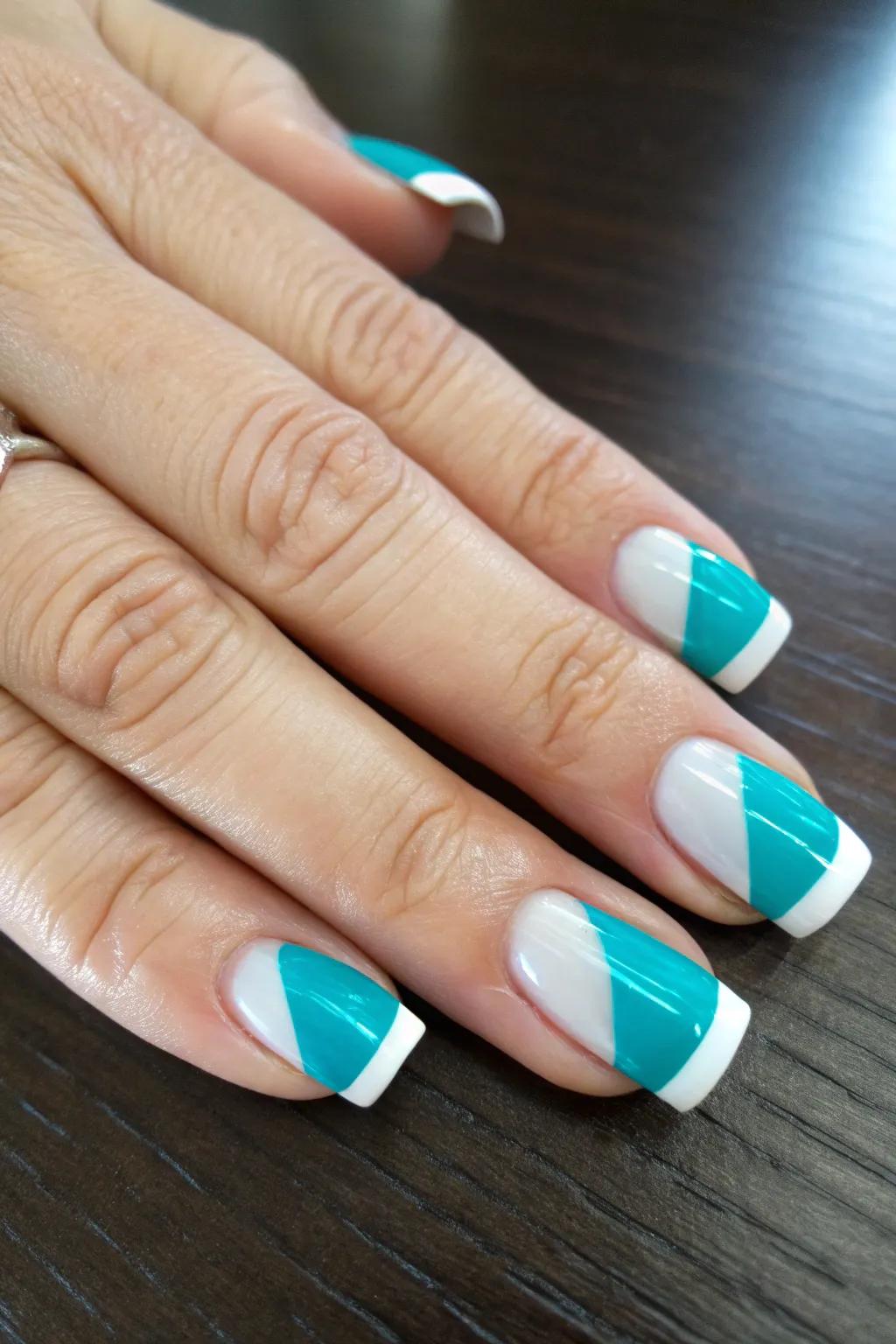 Reimagine classic elegance with a daring twist: captivating teal French tips for the modern artisan.